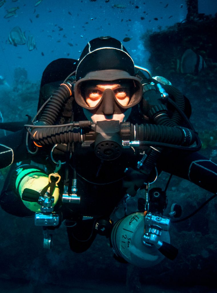 Underwater portrait of technical diver using a rebreather device to locate shipwreck, Lombok, Indonesia Underwater portrait of technical diver using a rebreather device to locate shipwreck, Lombok, Indonesia